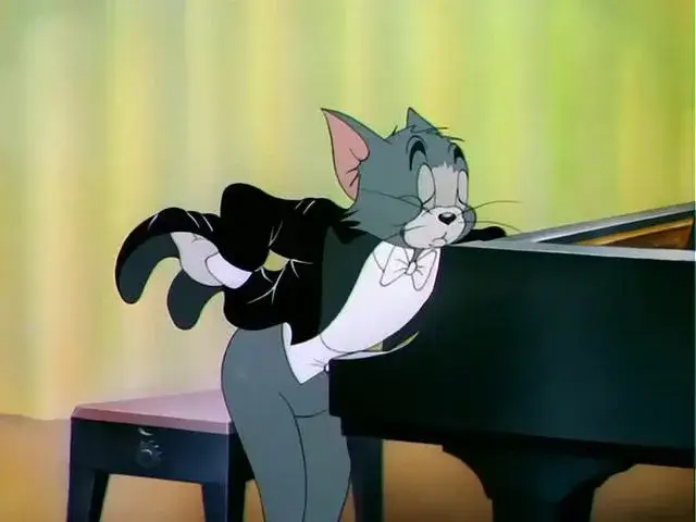 Hình mèo Tom mặc vest như quý ông sành điệu.đánh đàn Piano